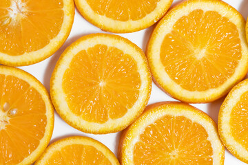 round slices of juicy orange on white background