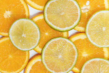 round slices of juicy orange and lime. background for your design