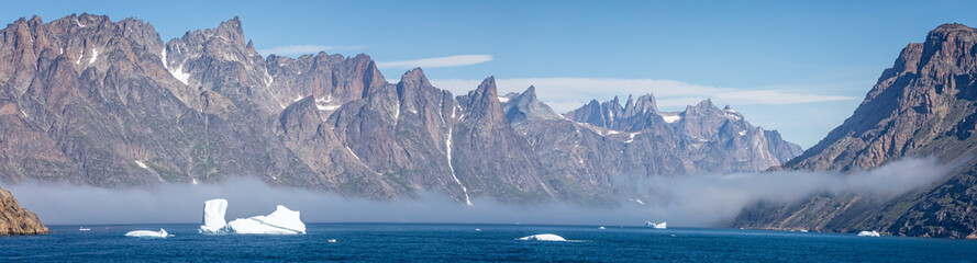 Panoramic landacpe of icebergs and mountains in Prince Christian Sound, South Greenland