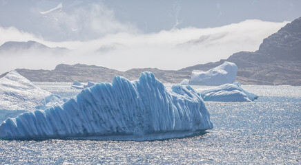 landscape of large icebergs and mountains in Prince Christian Sound, South Greenland © Nigel