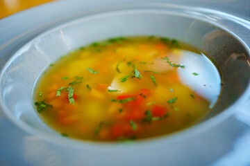 the soup with meat and lentils in a plate. 