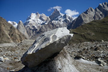 A rock piece before Baintha Brakk or 'The Ogre' is a steep, craggy mountain, (7,285 meters) in Panmah Muztagh, a sub range of Karakoram range. It is on the brink of 67 kilometers long Biafo Glacier - obrazy, fototapety, plakaty