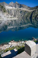 mountain reflection in still blue water lake