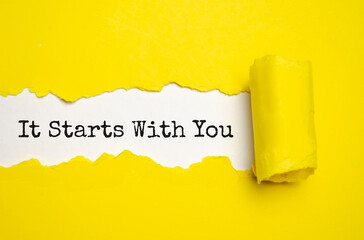 IT STARTS WITH YOU. words. text on yellow paper on torn paper background - obrazy, fototapety, plakaty