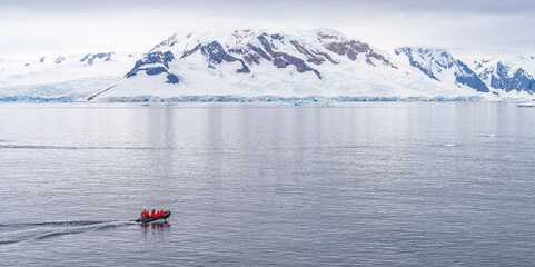 Expeditions - Zodiak fährt durch antarktische Eisberg Landschaft bei Portal Point welches am...