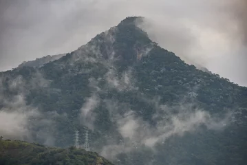 Fotobehang The cloud-shrouded Pico do Andaraí Maior peak above the dense Atlantic rainforest of the Tijuca National Park, Rio de Janeiro, Brazil © Pedro