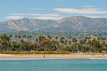 Santa Barbara beach and ocean view, palm trees, mountains, and cloudy sky on background - obrazy, fototapety, plakaty