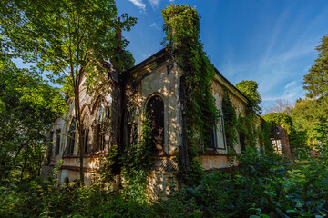 Old ruined overgrown abandoned historical Khvostov's mansion in Gothic style