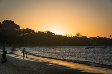 People on the beach at sunset at Buzios town, State of Rio de Janeiro, Brazil. Taken with Nikon...