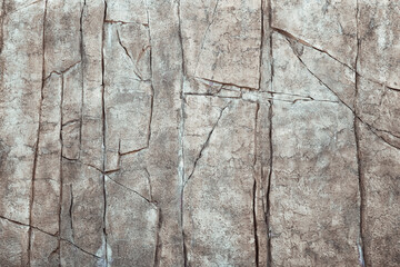 Tall Stone Wall with Large Fissures and Rough Natural Cracked Grunge Textures