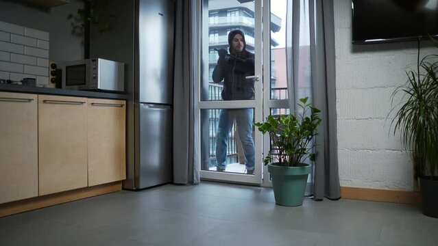 Burglar robber break door lock and entering building apartment. house robbery, Home Burglary. intruder or thief with crowbar in black clothes stealing break door to enter the private property indoor