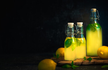 lemonade in bottle with mint leaves dark food photography 