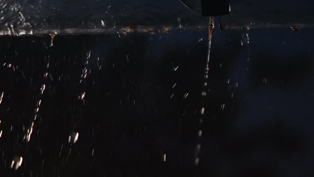 Drops fall from the roof edge
