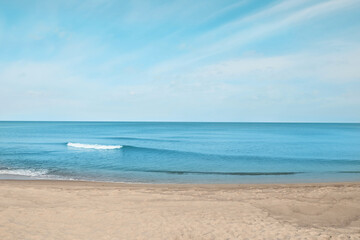Beautiful view of sea shore under blue sky on sunny day