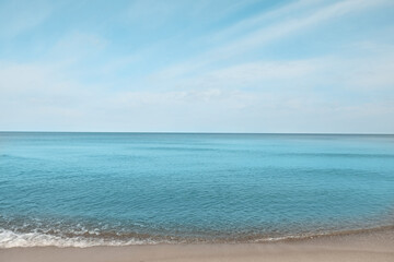 Beautiful view of sea shore under blue sky on sunny day
