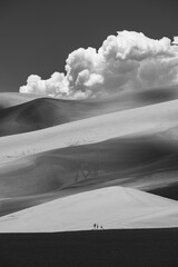 Tourists standing by the big sand dunes of Great Sand Dunes National Park, Colorado