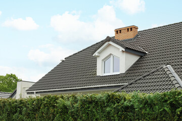 Modern building with grey roof outdoors on spring day