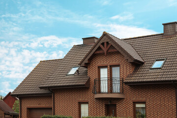 Beautiful house with brown roof against blue sky