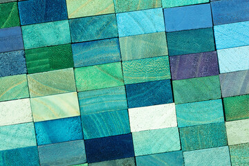 Spectrum of multi colored wooden blocks aligned in blue tone. Background or cover for something...