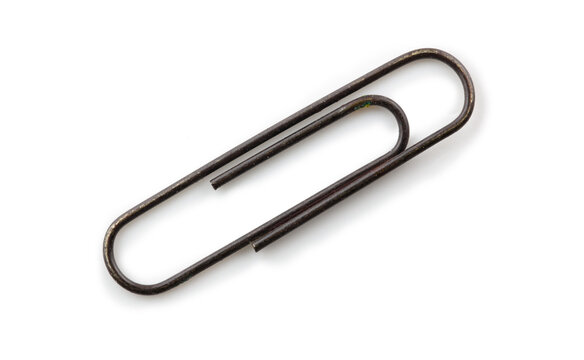 Old rusted paper clip, isolated on white, with natural shadows.