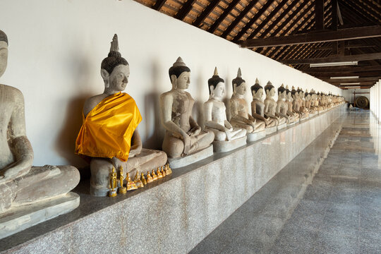 Row of stone Buddha in local temple of Thailand.