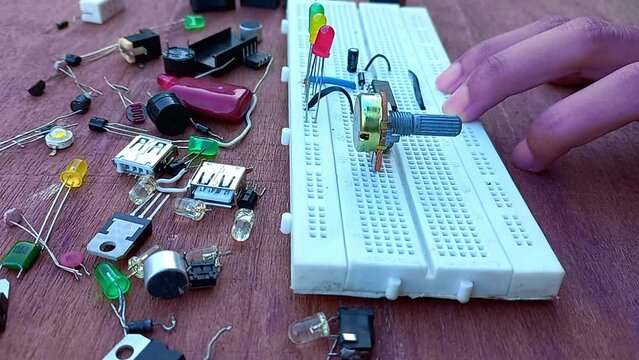 hand making electronic circuit on breadboard