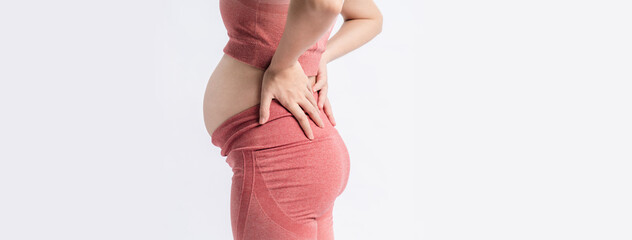 Pregnant back pain symptom. Closeup pregnancy touching or massaging on her back ache. Back Ache of...