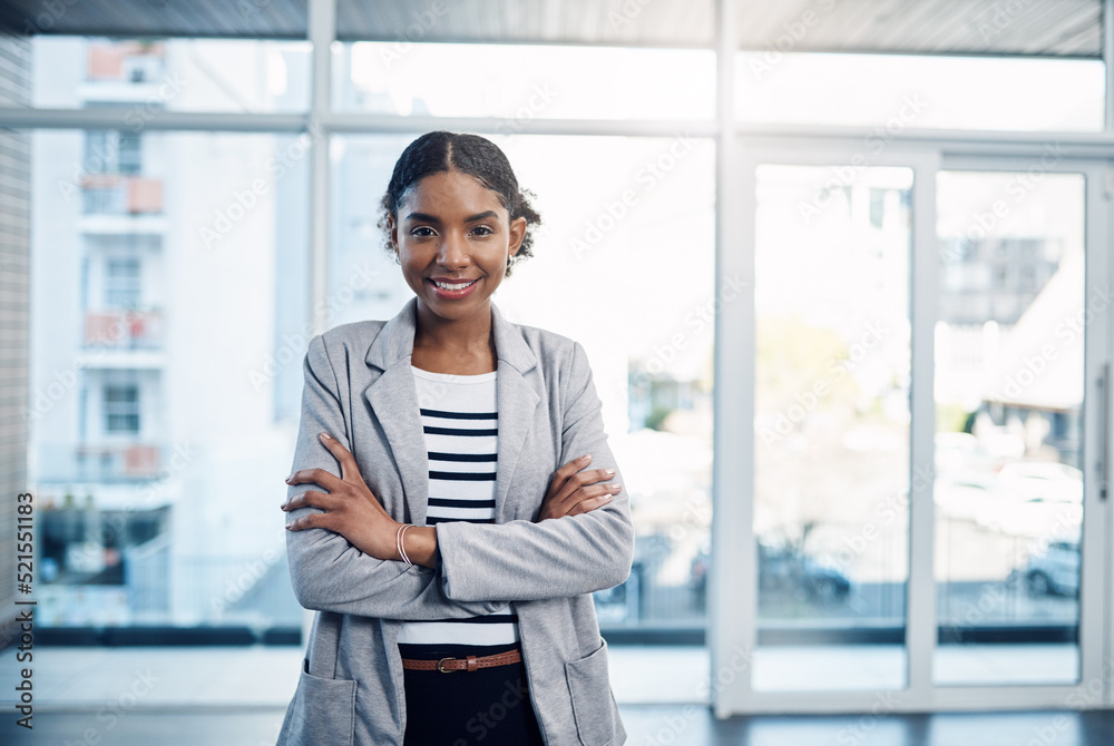 Canvas Prints Confident, proud and professional young black business woman folding her arms and smiling in a modern office. Portrait of African American leader looking powerful, successful standing in power stance