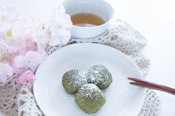 Japanese food, yomogi mochi on dish with barley tea 