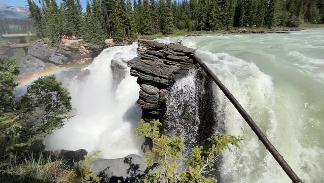 Majestic Athabasca Falls cascading down the rocky cliffs of Jasper National Park, Alberta, Canada. Beautiful view of Athabasca Falls and the powerful waters rushing through its narrow gorge