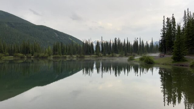 Forget-me-not Pond in Kananaskis Country by Calgary, Alberta. A peaceful, serene landscape with a stunning reflection of the surrounding mountains. 