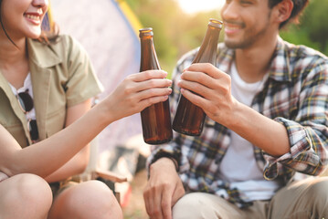 asian couple camping outdoors and eat food.