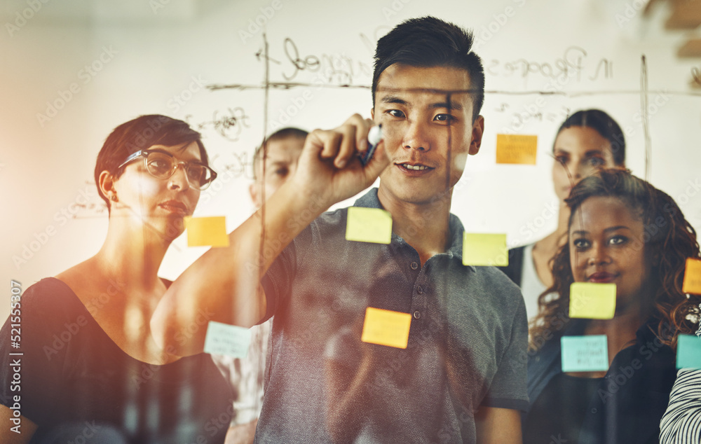 Poster team leader planning and writing on sticky notes while brainstorming, talking and sharing vision or 