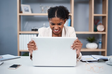Frustrated, angry and stressed young business woman on a laptop in a modern office. Female showing anger with technology at the workplace. Lady employee grabbing computer due to slow connection - obrazy, fototapety, plakaty