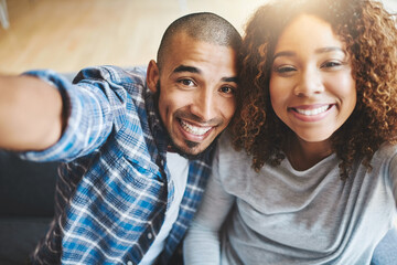 Happy couple taking selfies as home owners, bonding or enjoying new real estate purchase. Portrait...