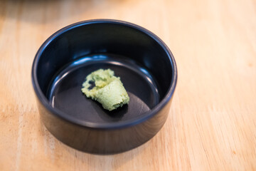 A little wasabi on a black bowl