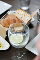 A view of a basket of house bread, in a restaurant setting.