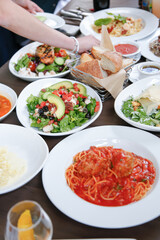 A view of a restaurant spread of assorted entrees.