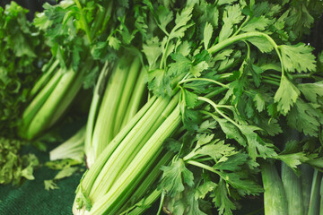 A view of several stalks of celery, on display at a local farmers market.