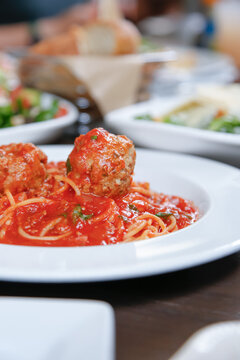 A Closeup View Of A Plate Of Spaghetti And Meatballs.