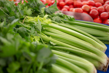 A view of a table full of celery, on display at a local farmers market.