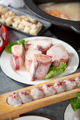 A view of a plate of frozen beef bone marrow, part of the ingredients of a hot pot dinner.