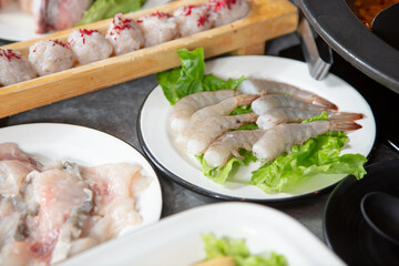 A view of a selection of raw seafood plates, part of a hot pot meal.