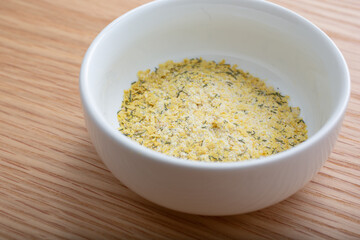 A view of a condiment up of dill flavored nutritional yeast.