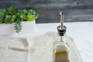 A view of an olive oil bottle, featuring a dispenser kit.