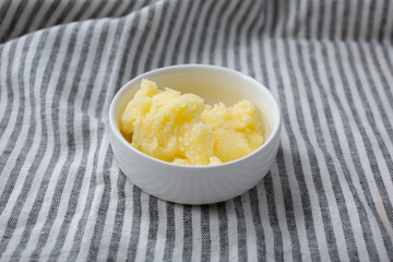 A view of a condiment cup of solidified ghee.