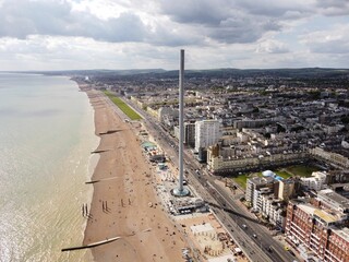 Drone view of British Airways i360 tower on a sandy beach in Brighton, East Sussex, England