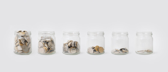 Glass jars with coins.Concept background for business,finance,.savings.Color toned in clean pastel.