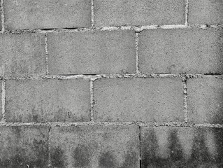 Close-up of White cement crack block wall and peeled paint caused by water and sunlight. Peel wall of White house paint with black stain. Black and White of Texture background.