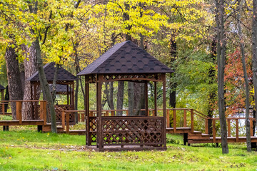 Empty wooden gazebos in city park on an autumn day no people